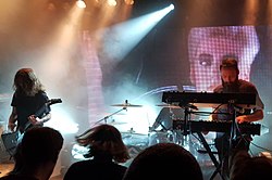 Carpenter Brut on stage with a band