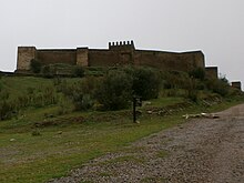 A perspective of the intact castle walls of the castle Castelo de Noudar - vista geral a partir da estrada.jpg