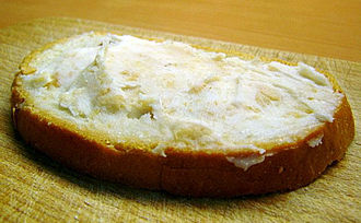 A slice of bread spread with lard was a typical staple in traditional rural cuisine of many countries Chleb ze smalcem.jpg