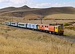 An NZR locomotive in International Orange livery EF30163+Overlander NearWaiouru 22March2003 JChristianson.jpg