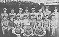 Eric Feldt (middle row, fourth from left) poses in a group photo with other coastwatchers somewhere in the Solomons in 1943 or 1944.