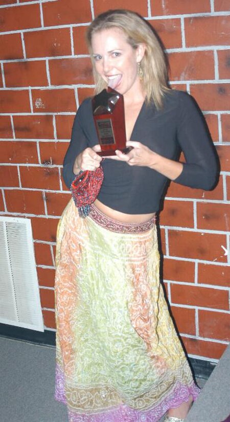 Holly Randall holding her mother's (Suze Randall) Lifetime Achievement Award trophy, which she accepted on her behalf at the 2005 NightMoves Awards Sh