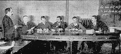 A photo from a 1902 New York Tribune article on Americanization, of Holyoke Frenchmen taking English classes at a YMCA night school Holyoke Frenchmen learning to read English at Night School (1902).jpg