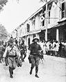 Japanese troops march through the streets of Labuan on 14 January 1942.