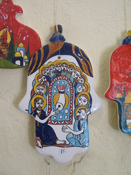 A ceramic hamsa depicting Jesus and his disciples