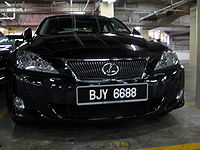 Front view of a compact sedan parked in Malaysian car parks.
