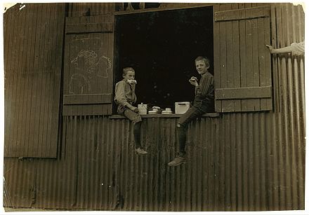 Lunch time for two boys employed at the Economy Glass Works in Morgantown, 1908. Photo by Lewis Hine.