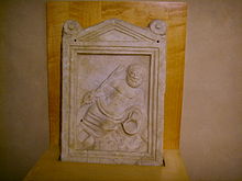 Bas-relief found under the entrance of the Gambrinus cinema representing a river divinity; this icon, which probably represents the Arno, was situated in a staircase which is believed to belong to the well coeval with the foundation of the city. Museo Firenze com'era, fonte sotterranea.JPG