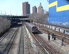 Open cut, looking west from 6th Avenue overpass, with the LIRR Bay Ridge Branch on the left and the BMT Sea Beach Line on the right. N approaching 6 Av in BR trench jeh.JPG