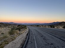 Pinto Basin Road at twilight, view towards the Colorado Desert portion of the park Pinto Basin Road Joshua Tree 2022.jpg