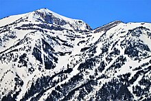 A plane flies past Jackson Hole Mountain Resort in its descent into Jackson Hole Airport.