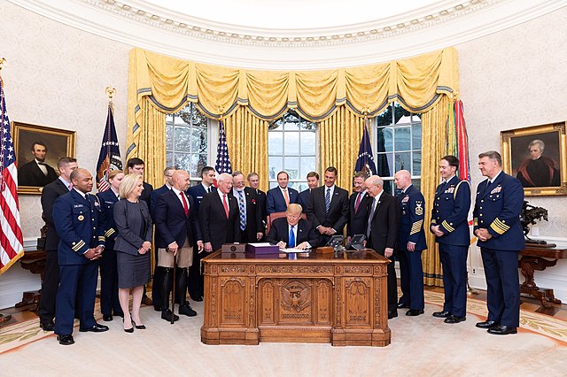 LoBiondo watches as President Donald Trump signs The Frank LoBiondo Coast Guard Authorization Act of 2018