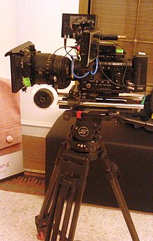 A Sony CineAlta movie camera (Sony F5) with 75mm lens, follow focus, 7" monitor on a Sachtler tripod Sony CineAlta with 75mm lens.jpg