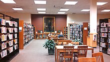 One of the reading areas of the library, with a painting of Ezra Cornell in the background Tompkins County Public Library reading area.jpg
