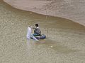 Zooming in on a fisherman in a rubber boat