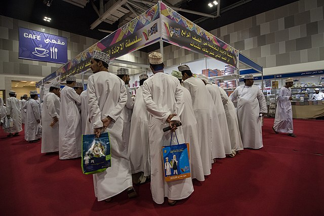 Omani men wearing thawbs at the Muscat International Book Fair.