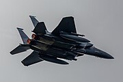 An F-15E Strike Eagle, tail number 91-0302, taking off from RAF Lakenheath in England. The aircraft is assigned to the 492nd Fighter Squadron.