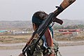 A soldier with the YPJ stares into the distance.jpg