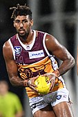 Archie Smith in 2019 as 202 cm (6 ft 8 in) Brisbane Lions ruck is the son of NBA basketballer Andre Moore