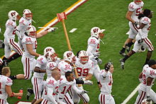 Badgers celebrate their win by carrying Paul Bunyan's Axe around TCF Bank Stadium after the 2009 game. Badgers carrying Paul Bunyan's Axe.jpg