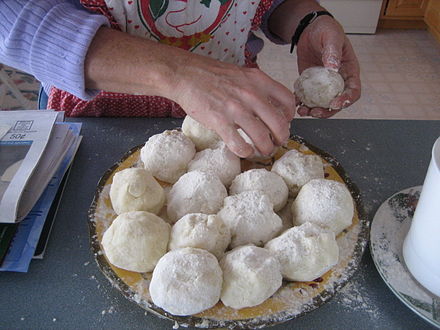 Balls of lefse dough waiting to be flattened with a rolling pin.
