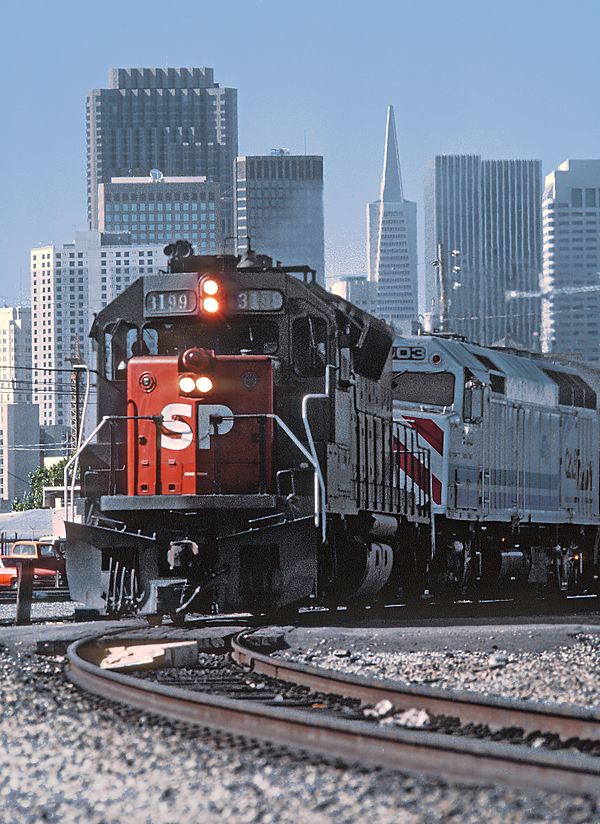 Changing of the guard: SP No. 3199 leads Caltrain No. 903 out of San Francisco (August 1985)