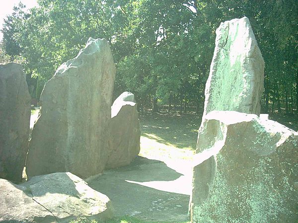 View looking west across the burial chamber with the facade stones visible on either side