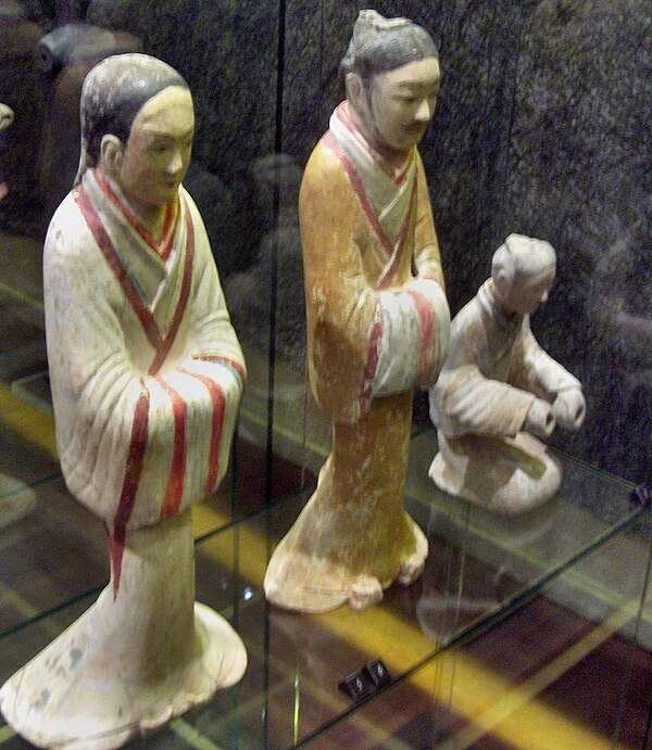 A female servant and male advisor dressed in silk robes, ceramic figurines from the Western Han era