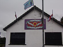 A wall sign in Dervock showing support for the North Antrim and Londonderry brigade. Dervock UDA wall sign.JPG