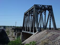 The historic Agua Fria River Bridge was built by the Santa Fe Railroad over the Agua Fria River in 1895. It is located on the right side of Grand Avenue if traveled from Phoenix to Wickenburg, close to 111 Ave. in El Mirage.