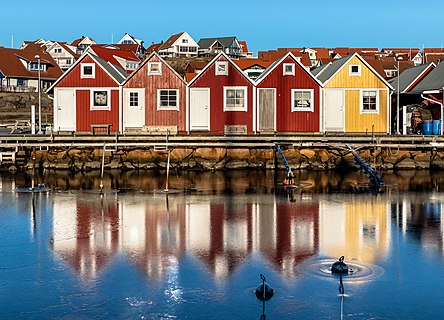 Fishing huts reflected in the ice at Fisketången, Kungshamn, Sweden.