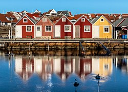 Fishing huts reflected in the ice at Fisketången, Kungshamn