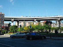 Freeway overpass over park, with graffiti about independence (18624560609).jpg