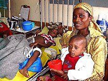 A hospitalized gunshot victim (left) from the 2001 Jos Riots Gunshot victim and mother.jpg