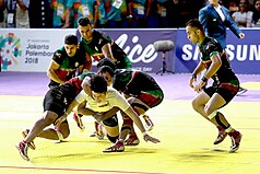 A Kabaddi raider trying to make it back over the midline while being tackled by the defensive team. Iran men's national kabaddi team 13970602000432636707284535394012 98208.jpg