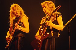 Murray (left) performing with Adrian Smith in 1982