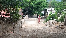 A view of the steps that lead up to Kaylartha Pagoda.  To the right is the monastic kitchen where nuns cook and serve breakfast and lunch to the monks and visitors.