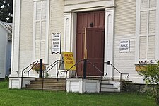 The small size of the town means that the library has limited hours of operation. Library Door Huntington Vermont USA.jpg