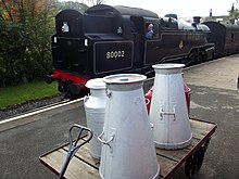 Milk churns on a railway platform Locomotive (8101317004).jpg