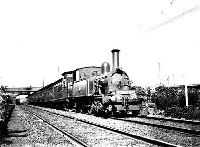 Steam-hauled suburban train departing North Melbourne station for Sunshine in April 1913