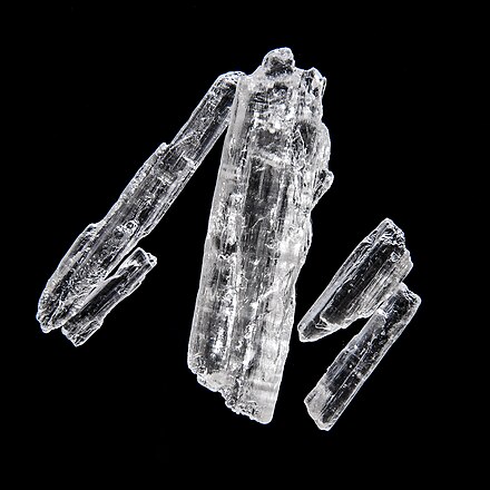 Menthol crystals at room temperature. Approx. 1 cm in length.