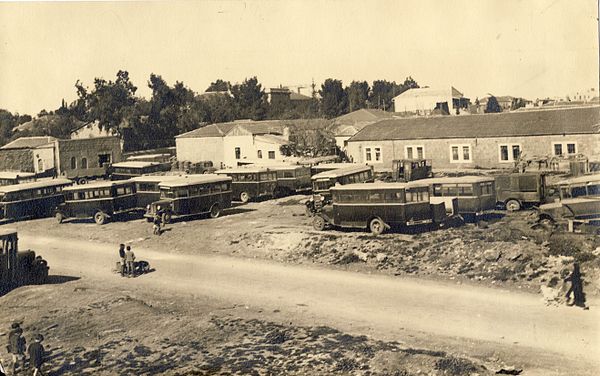 Hamekasher buses park outside Sha'arei Yerushalayim neighborhood on Jaffa Road in the 1930s