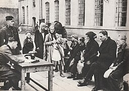 Recording names by the German police in the German Nazi camp in Łódź. World War II.jpg