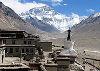 The Rongbuk Monastery, with Mount Everest's north face (background). The expedition members were blessed at the monastery by the lama. Rongbuk Monastery Everest.jpg