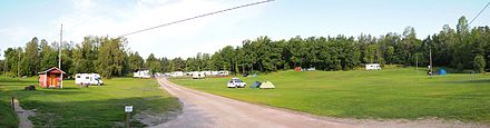 Campsite in Turku, Finland; tents on the lawn, motorhomes and caravans in the background