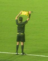 The assistant referee indicating a substitution Senal de Cambio de Jugador cropped.JPG