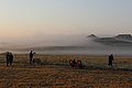 Sunrise light on low fog and people scattered across a grassy area with cameras and telescopes (498a29d2-8fed-4b80-80f7-31393d088ba5).jpg