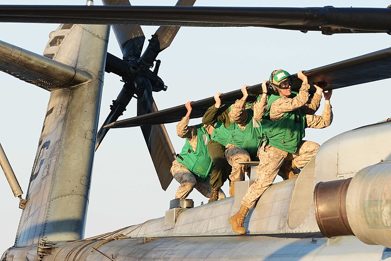 File:U.S. Marines from the 22nd Marine Expeditionary Unit align the rotor blades of a CH-53E Super Stallion helicopter for stowage following a day of flight operations aboard the amphibious assault ship USS Bataan ( 131024-N-RB564-151.jpg