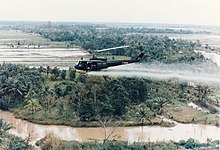 U.S. Army Huey helicopter spraying Agent Orange during the Vietnam War US-Huey-helicopter-spraying-Agent-Orange-in-Vietnam.jpg