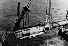 One of California's guns being raised from the ship to lighten her before being raised, c. February 1942 USS California gun being raised NH 64487.tiff